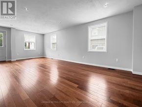 Renfrew apartment for rent - A spacious room with wooden flooring and white walls.