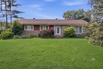 Ottawa apartment for rent - A house with a red roof and a green lawn in front.