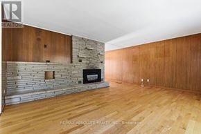 Ottawa apartment for rent - A room with wooden floors and a stone fireplace.