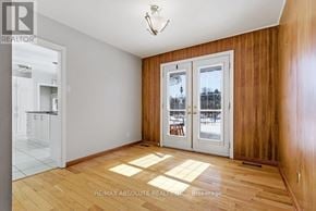 Ottawa apartment for rent - A room with wooden floors and a sliding glass door.