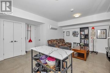 Ottawa duplex for rent - A white kitchen with a table and a couch.