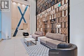 Toronto (Church-Yonge Corridor) condo for rent - A modern living room with a large X-shaped decoration on the wall.