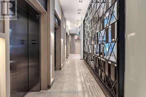 Toronto (Church-Yonge Corridor) condo for rent - A long hallway with elevators on the left and a wall of windows on the right.
