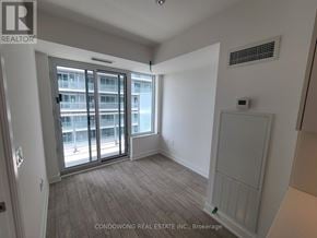 Toronto (Mount Pleasant West) condo for rent - A room with a large window and a door leading to a balcony.