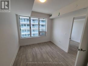 Toronto (Mount Pleasant West) condo for rent - A room with a large window and wooden flooring.