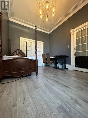 Toronto (Kensington-Chinatown) apartment for rent - A bedroom with a four poster bed and a piano.
