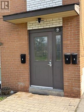 Mississauga (Streetsville) multi-family for rent - A grey door with a number 9 above it.