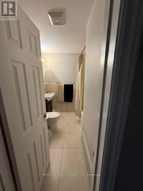 Mississauga (Streetsville) multi-family for rent - A white door is open to a bathroom with a toilet and a shower.