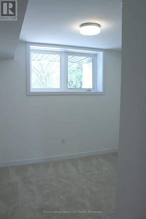 Guelph (Clairfields/Hanlon Business Park) townhouse for rent - A white room with a window and a light on the ceiling.
