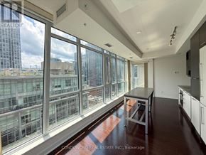 Toronto (Waterfront Communities) condo for rent - A sunny day in a city with a view of the buildings from a high-rise apartment.