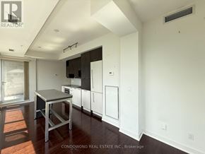 Toronto (Waterfront Communities) condo for rent - A kitchen area with a table and a window.