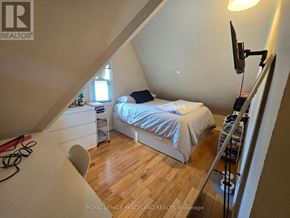 Toronto (Kensington-Chinatown) multi-family for rent - A bedroom with a bed, desk, and chair.