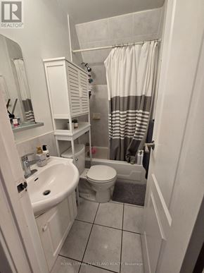 Toronto (Kensington-Chinatown) multi-family for rent - A white bathroom with a sink, toilet and shower.