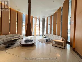 Toronto (Bay Street Corridor) condo for rent - A spacious living room with a large window and a long white sofa.