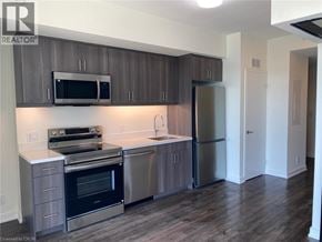 Welland condo for rent - A kitchen with a stove, oven, refrigerator, and microwave.