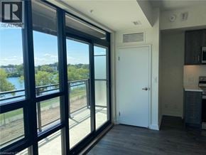 Welland condo for rent - A room with a large window overlooking a body of water.