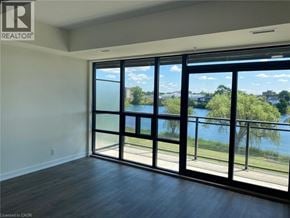 Welland condo for rent - A room with a view of a lake through large windows.
