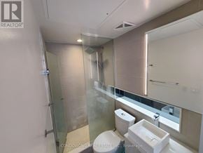 Toronto (Waterfront Communities) condo for rent - A modern bathroom with a walk-in shower and a toilet.