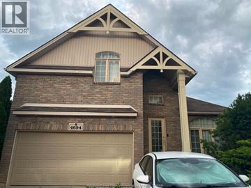 Windsor apartment for rent - A house with a garage door and a car parked in front.
