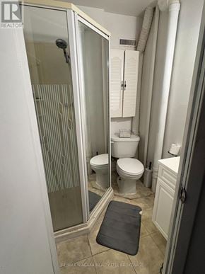 Welland (Lincoln/Crowland) apartment for rent - A bathroom with a toilet, sink, and walk-in shower.
