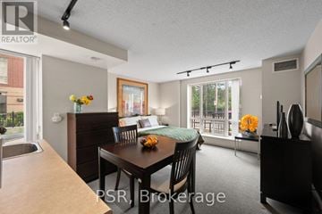 Toronto (Lawrence Park South) condo for rent - A dining room with a table set for two and a view of the backyard.