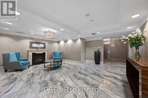 Toronto (Lawrence Park South) condo for rent - A living room with a fireplace and blue chairs.