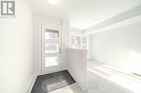 Toronto (Bendale) townhouse for rent - A white door with a glass window and a sign that says "REALTOR" on the wall above it.