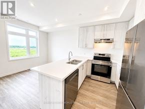 Richmond Hill townhouse for rent - A modern kitchen with stainless steel appliances and wooden flooring.