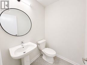Richmond Hill townhouse for rent - A white sink and toilet in a small bathroom.