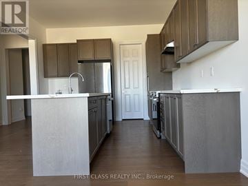 Georgina (Keswick North) apartment for rent - A kitchen with a white counter top and stainless steel appliances.