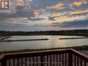 Georgina (Keswick North) apartment for rent - A view from a balcony overlooking a body of water with a sunset sky.