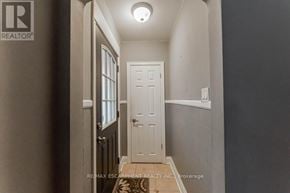 Hamilton (Inch Park) apartment for rent - A hallway with a white door and a light on the ceiling.