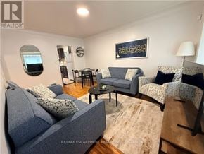 Hamilton (Inch Park) apartment for rent - A living room with a grey couch and a small table.
