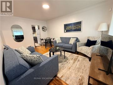 Hamilton (Inch Park) apartment for rent - A living room with a grey couch and a small table.