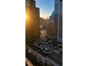 Vancouver apartment for rent - A sunset view of a cityscape with the sun setting behind the buildings.