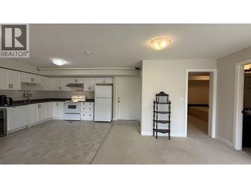 Coquitlam apartment for rent - A spacious kitchen with white cabinets and a large island.