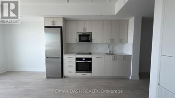 Oshawa (Windfields) condo for rent - A kitchen with white cabinets and appliances is for sale.