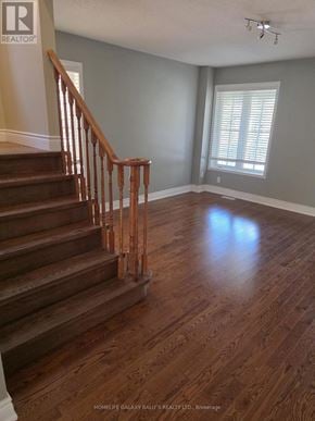 Ajax (Northeast Ajax) apartment for rent - A wooden staircase leads up to a window in a room.