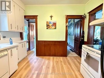 Markham (Unionville) apartment for rent - A kitchen with white cabinets and a wooden wall.