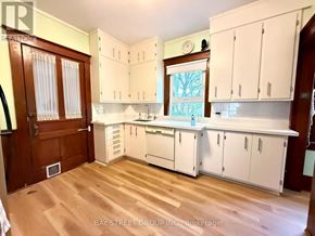 Markham (Unionville) apartment for rent - A kitchen with white cabinets and a wooden floor.