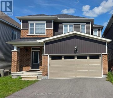 Ottawa apartment for rent - A two-story house with a garage door is for sale.