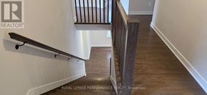 Ottawa apartment for rent - A wooden staircase with a metal railing.