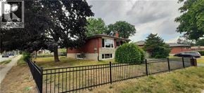 Kitchener apartment for rent - A house with a black fence in front of it.
