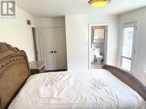 Toronto (Lansing-Westgate) apartment for rent - A bedroom with a bed, a toilet, and a sink in the background.