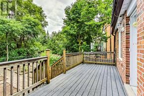 Toronto (Lansing-Westgate) apartment for rent - A wooden deck leads to a lush green backyard.