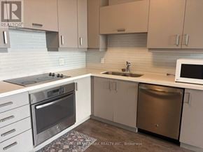 Markham (Unionville) condo for rent - A kitchen with a stove top oven, microwave, and dishwasher.