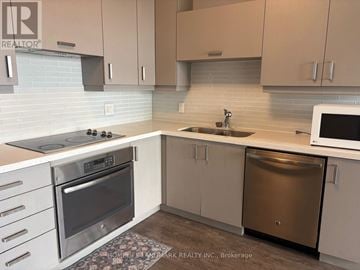 Markham (Unionville) condo for rent - A kitchen with a stove top oven, microwave, and dishwasher.