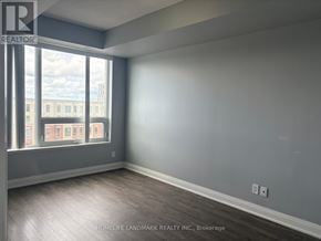 Markham (Unionville) condo for rent - A room with a large window and wooden flooring.