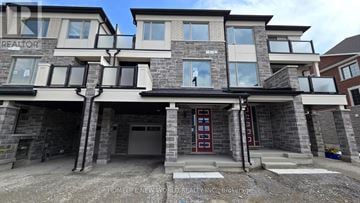 Markham townhouse for rent - A large, modern house with a stone facade and a garage.