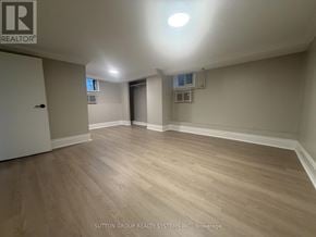 Toronto (Mount Dennis) apartment for rent - A room with wooden flooring and a ceiling light.